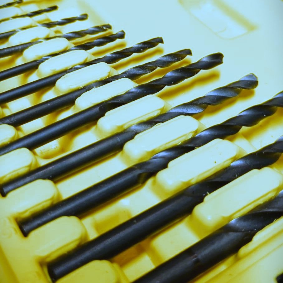 Set of drill bits arranged in a yellow case. Engineering. Manufacturing.