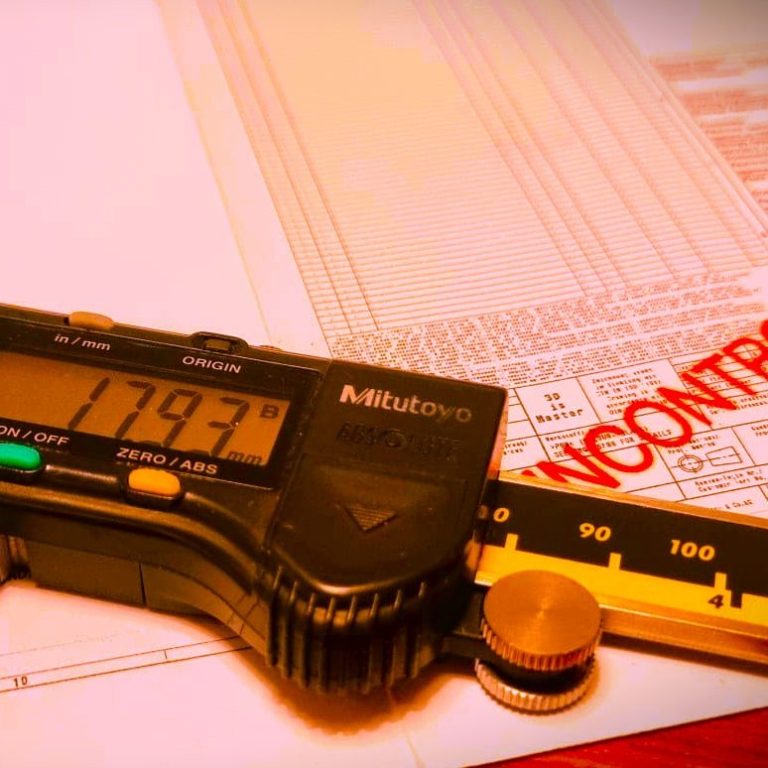 Digital vernier caliper displaying measurement on a paper with "UNCONTROLLED" highlighted.